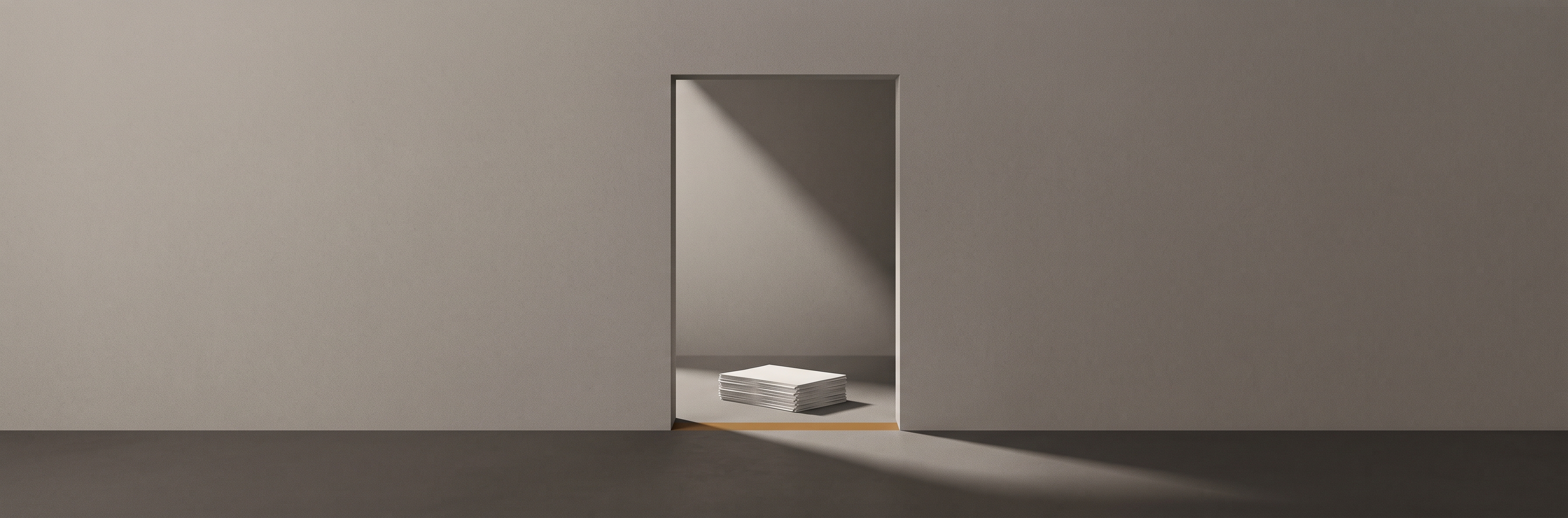 A doorway cut into a plain wall, light falling across a bare floor and a stack of paper sheets just inside it.