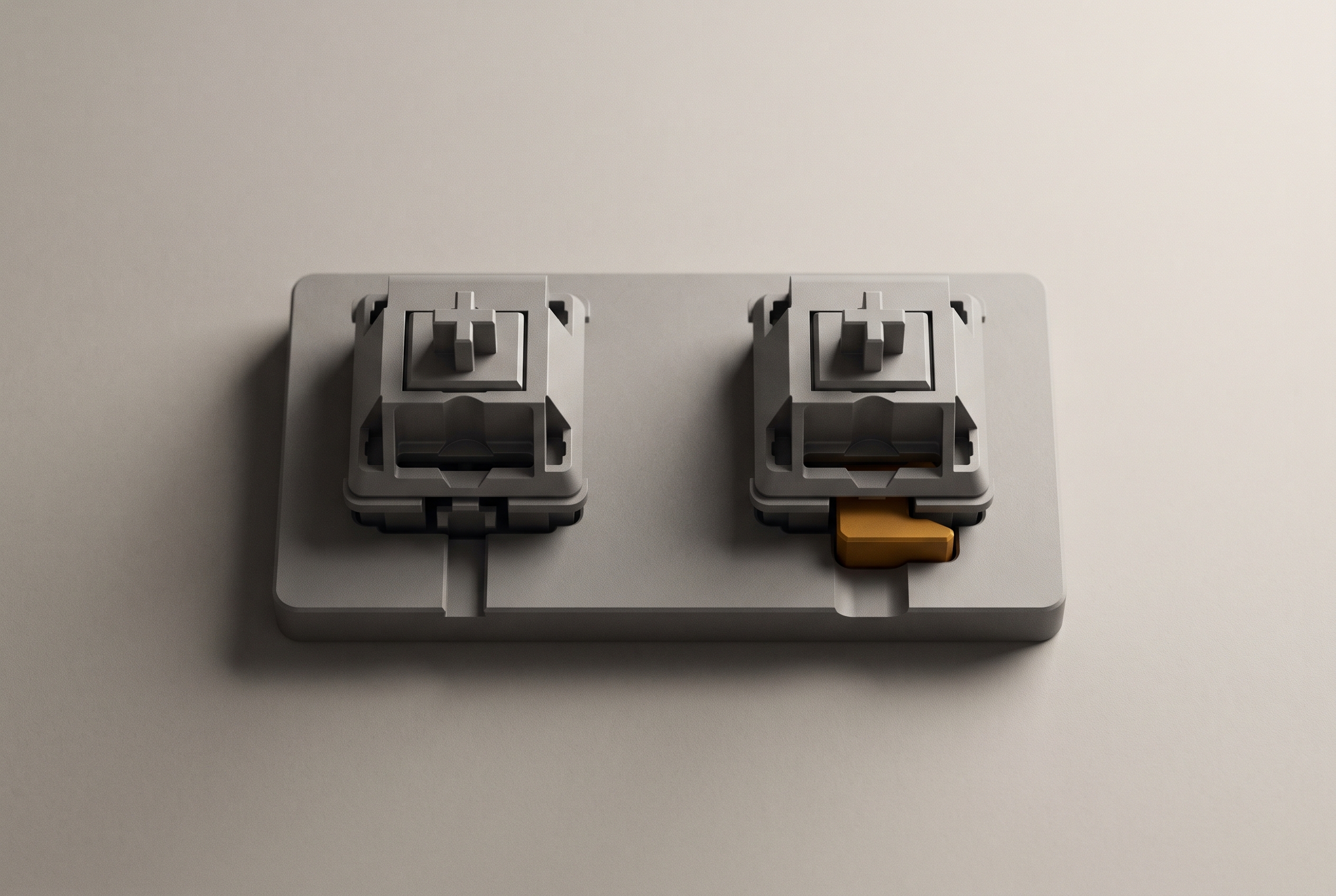 Two identical grey switches mounted on a plate, one with a track that lets its lever return and one with a catch behind it.