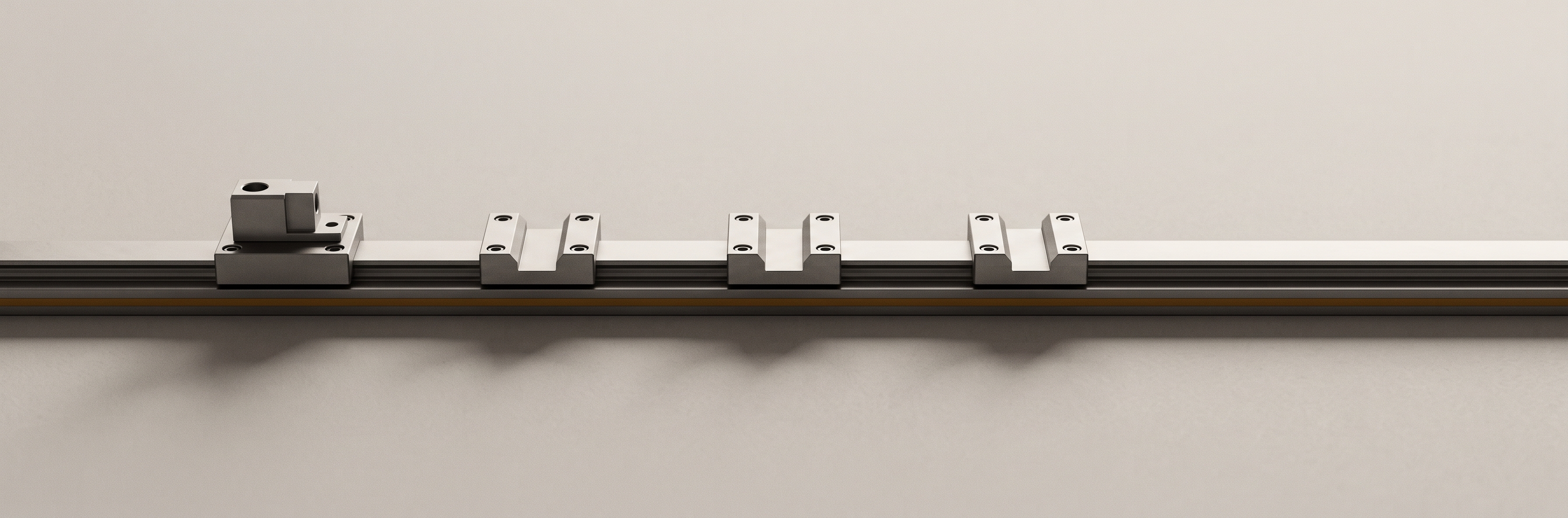 A single machined rail running the width of the frame, with four mounting saddles bolted along it, one holding a component.