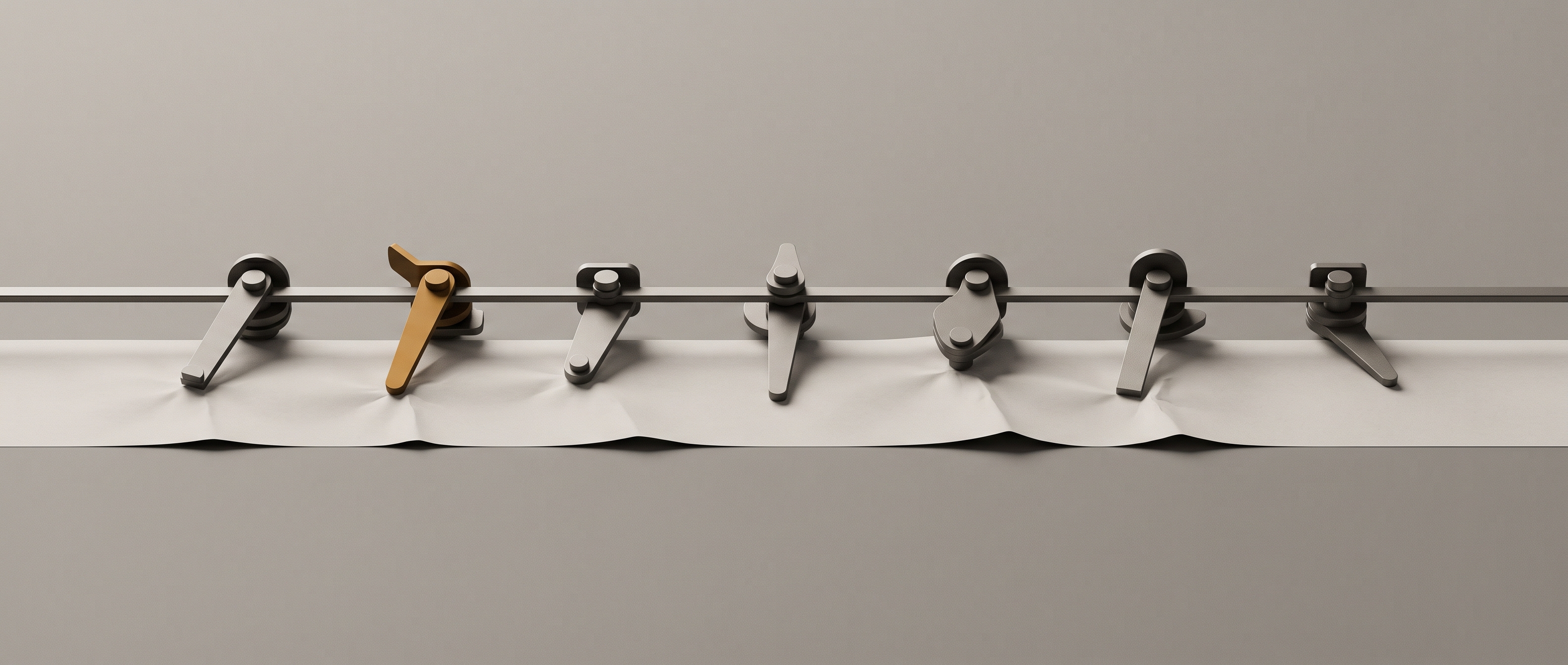 A row of machined levers on a shared rail, each pressing at a different angle against one continuous sheet of paper.
